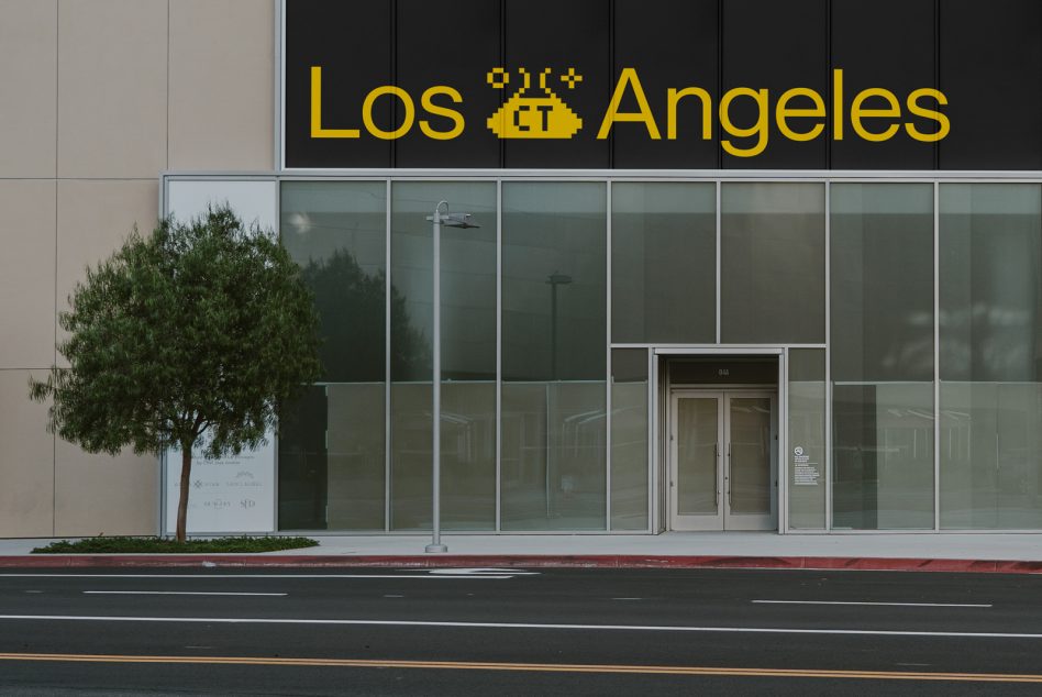 Modern storefront mockup with pixelated Los Angeles sign above glass entrance doors for urban design presentation.